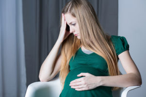 young, expecting woman wondering whether or not it's safe to detox while pregnant
