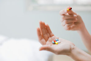 medication for alcohol withdrawal in woman's hand