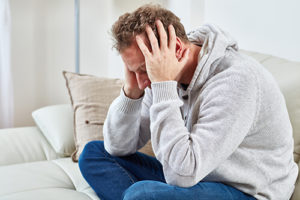 man has a headache from dangerous painkillers