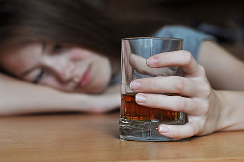 young woman with whiskey attempts to define sobriety