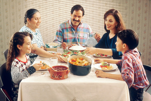Hispanic family having dinner.